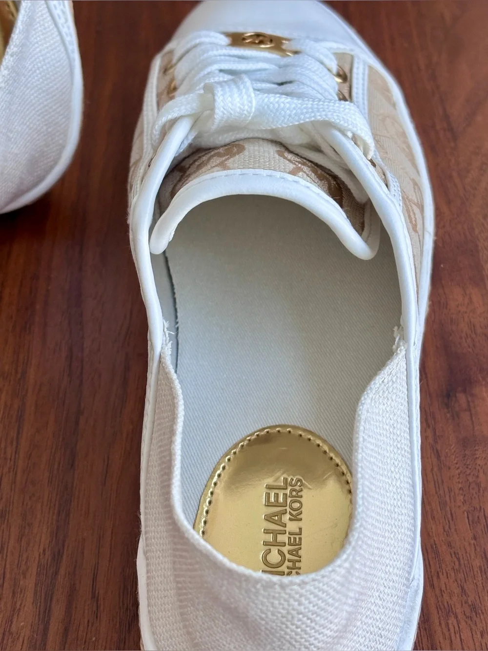 Brand New pair of Michael Kors Kristy Slide Sneakers in a cream and beige, 6.5.